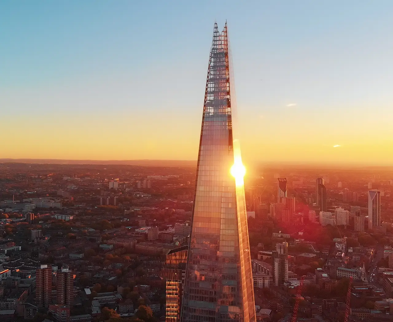 View across London at sunset with The Shard in view, we specialise in finding our clients luxurious properties | IIG Estates