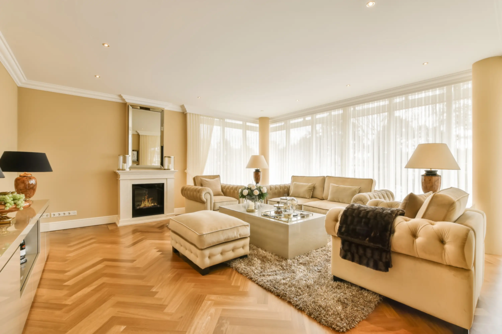Beautiful cream coloured living room with an amazing fireplace | IIG Estates