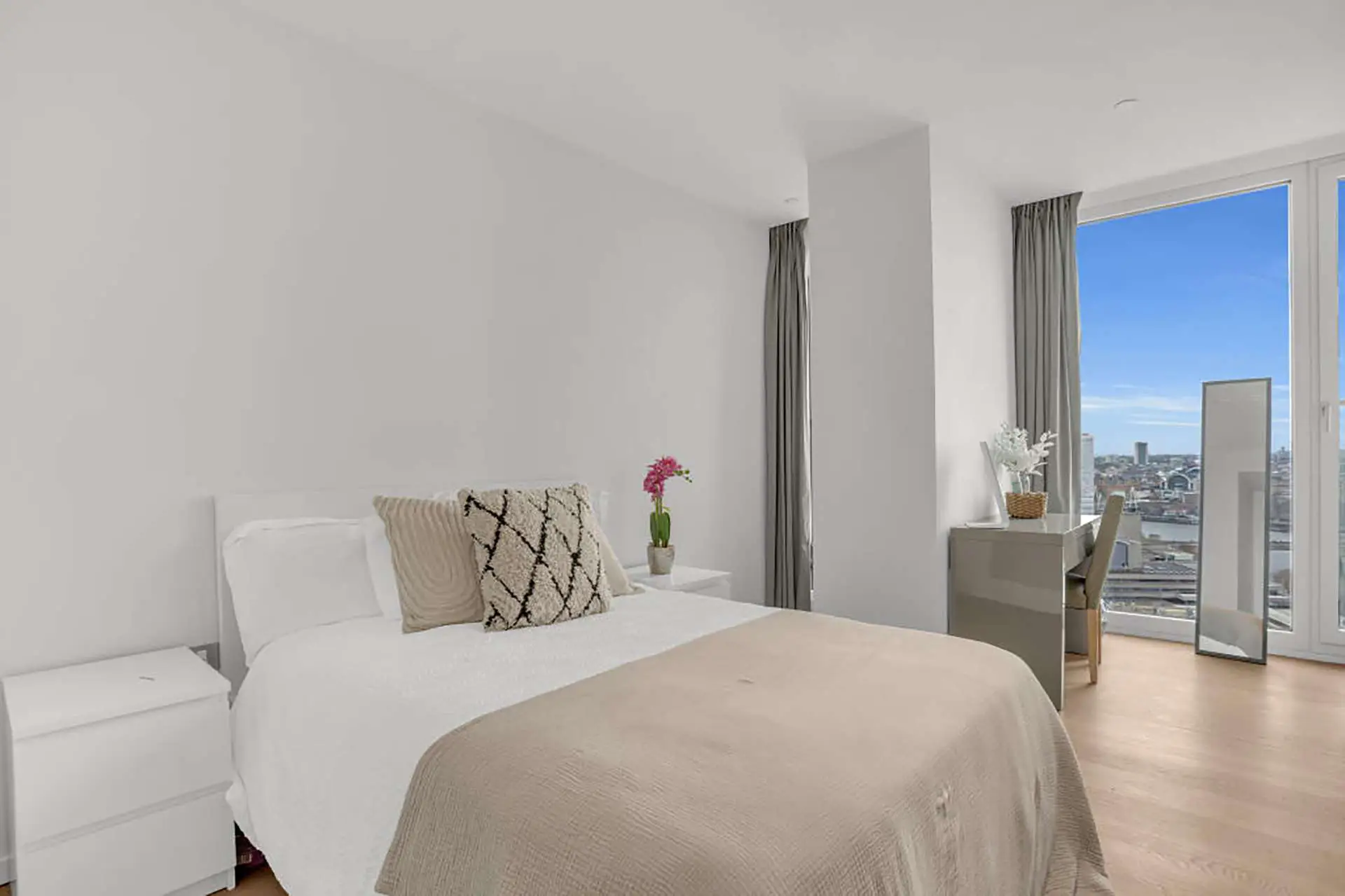 Master bedroom with large window and view across London, in Upper Ground London SE1 | IIG Estates